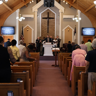 Congregation standing for worship during Sunday service at Calvary Bible Baptist Church