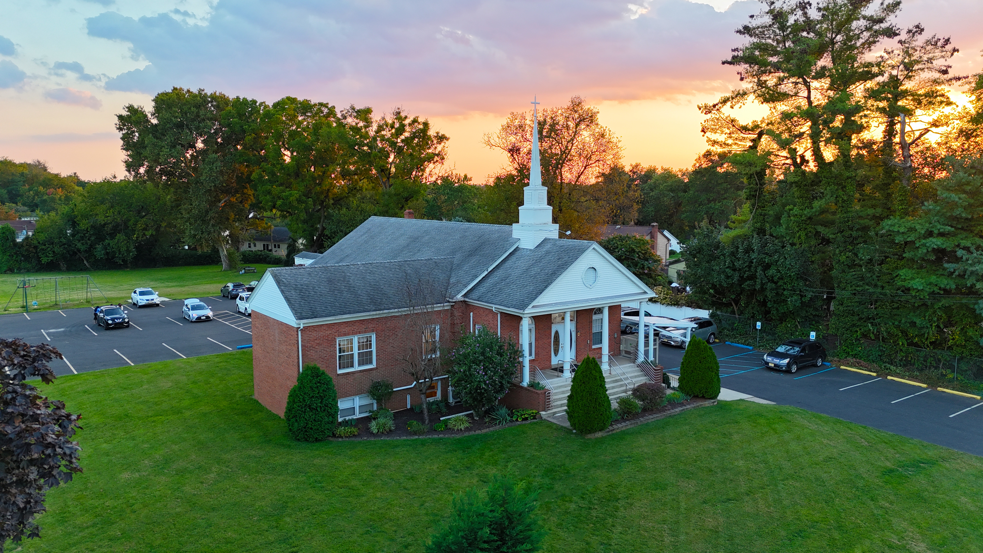 Aerial view of Calvary Bible Baptist Church in Willingboro, NJ during fall sunset