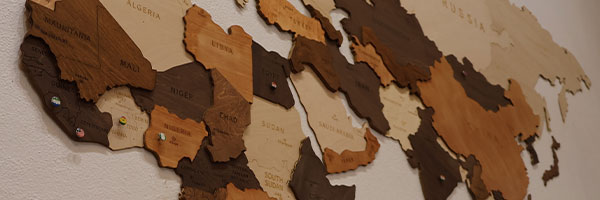 Wooden world map with missionary pins on wall at Calvary Bible Baptist Church